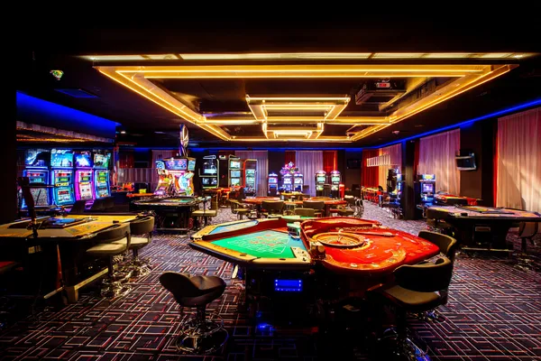 A player using their smartphone during a festive local event, representing 88FD’s fully mobile-friendly casino.